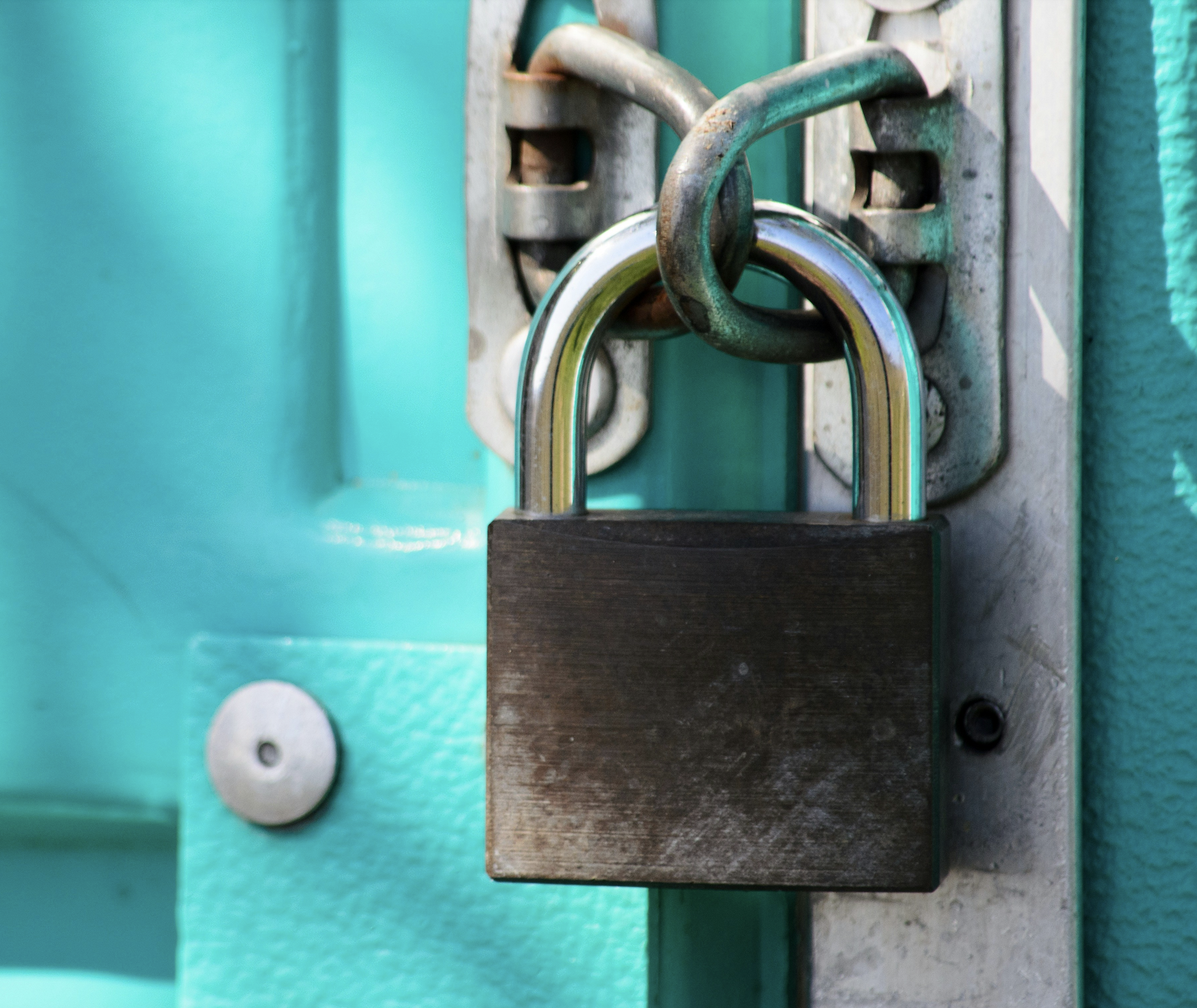 A padlock securing a chained door